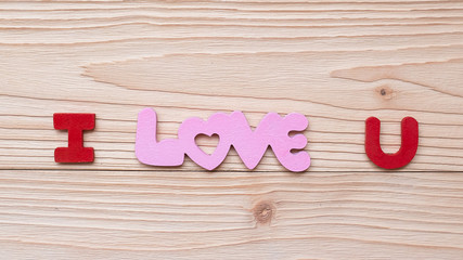 I Love U text on wooden table background. romantic and Valentine Day holiday Concept