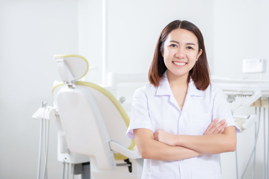 Portrait of female dentist standing in dental office