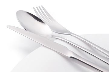 Cutlery on white empty plate isolated with clipping path