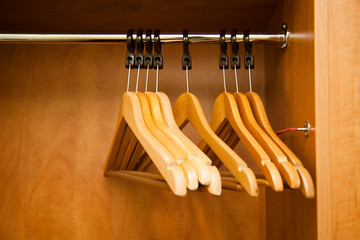 Empty clothes hangers in the hotel wardrobe