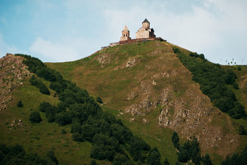 Gergeti Trinity Church on hill near Stepantsminda, Georgia