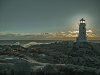 Peggy's Cove lighthouse at sunset in the winter, tourist, cold, Atlantic Ocean, seaside