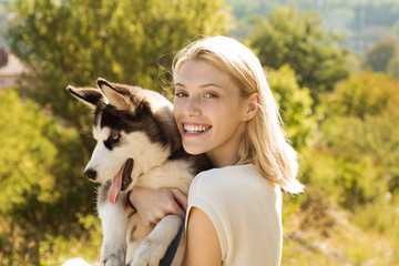 Canine companion. Happy dog owner play with family pet outdoor. Sexy woman with dog pet on summer day. Happy girl hold pedigree dog. This girl loves her siberian husky