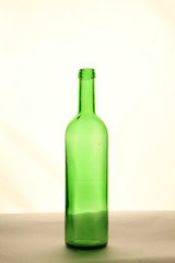 The green bottle empty is on a table a transparent background