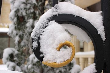 Fragment of a winter snow iron fence. 