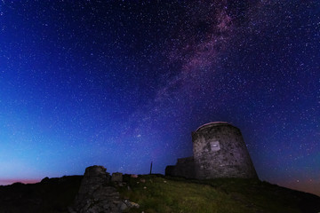 The fiery galaxy Milky way in the night sky with millions of stars over the White Elephant Observatory, which is in the Ukrainian Carpathian Mountains