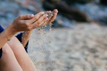 Fototapeta na wymiar Detail of sand running through open hands.