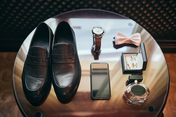 different accessories of a businessman for creating a style of a people lie on a wooden background