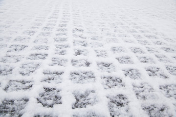 Snow covered pavement on the street in the city. Prague, Czech Republic