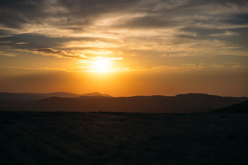 Orange majestic sunset in the mountains landscap.