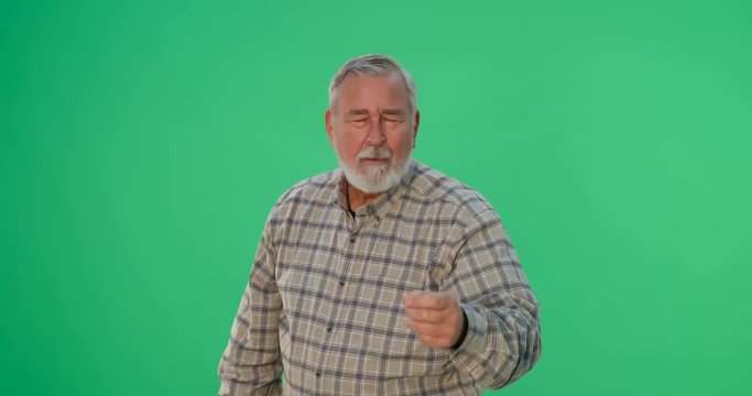 Old man shakes his finger in disgust as he scolds you, then folds his arms and shakes his head as if completely fed up. 4k footage shot on a chroma key green background.