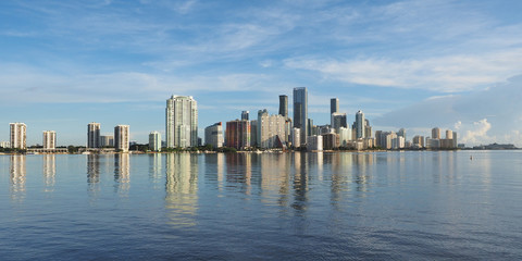 Miami, Florida 09-08-2018 City of Miami skyline and its reflection on the tranquil water of Biscayne Bay.