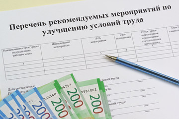 Form in Russian: "List of recommended measures to improve working conditions", ballpoint pen and new ruble bills. Summing up the results of the special assessment