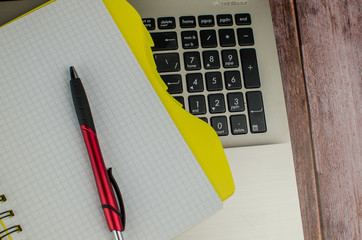 Pen and notebook on laptop. copy space