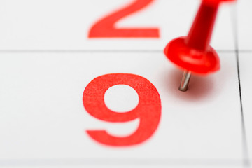 Pin on the date number 9. The ninth day of the month is marked with a red thumbtack. Pin on calendar