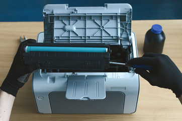 Laser cartridge toner refill or repair concept. Office equipment maintenance concept.