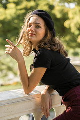 Fototapeta premium The girl in beret and skirt in the park 