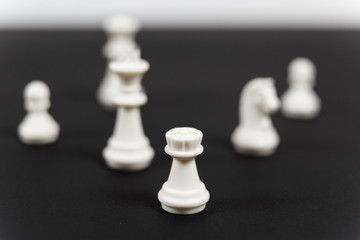 A human hand moving King chess piece at table