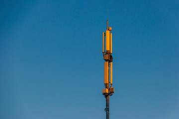 Telecommunication tower Antenna and satellite dish at sunset sky background