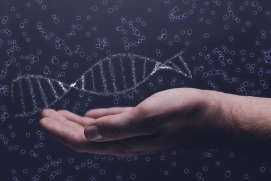 Close up of man holding DNA molecule in palm