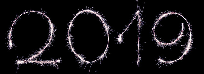New Year 2019 text written sparkles fireworks. Golden numbers 2019 isolated on black background for design