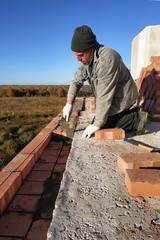 The builder uses a cement mortar for the construction of a brick wall