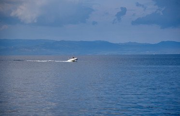 Fototapeta na wymiar Boat in the calm sea at the reception plan water