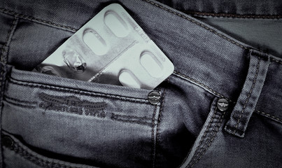 
Blister pack of white pills in jeans pocket