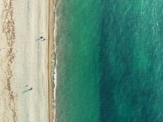 Sea aerial top view from drone. Azure ocean water and yellow sand beach as tropical vacation background with copy space