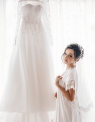 Beautiful brunette bride with stylish make-up in white dress