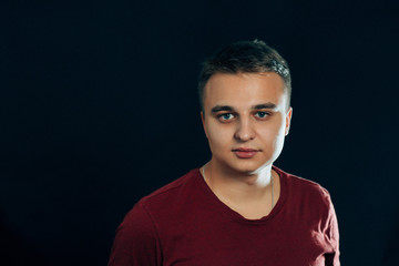 portrait of a young man on a dark background