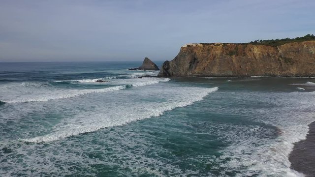 West Portugal aerial flight over Atlantic coastline ocean waves reachin Odeceixe beach