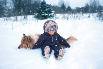 Winter portrtrait of baby and dog