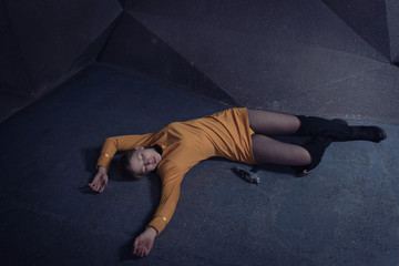  Lifeless unconscious woman lying on a factory floor