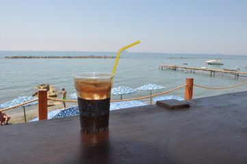 A tall glass of Traditional Cold Greek Coffee frappe