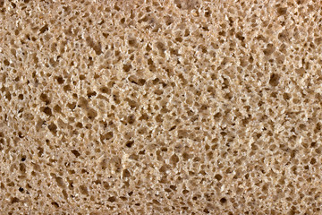 texture of brown rye bread, pie, cake, edible finely porous texture