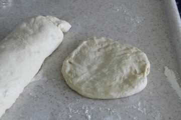 kneading dough at home, a woman making donuts with dough, make homemade pastries and donuts,