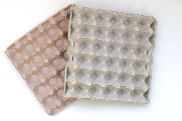 empty egg box on black and white backdrop,