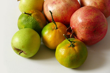 tangerine and pomegranate on white background autumn and winter berries mandarin and pomegranate