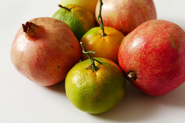 tangerine and pomegranate on white background autumn and winter berries mandarin and pomegranate