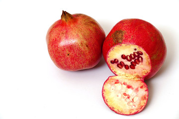 pomegranate fruit on white ground, grains of pomegranate fruit,