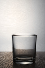 Empty glass for whiskey on a light background