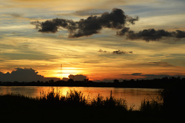 Silhouette landscape Sunset on the river Sky and clouds of orange