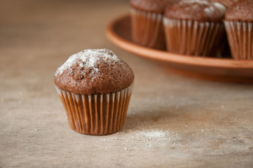 close-up of a muffin on the background of a plate with muffins, selective focus.