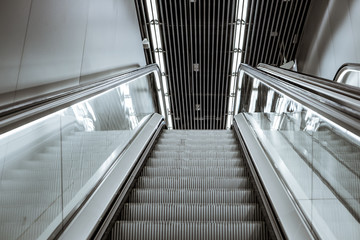 Escalator in a shopping center in Europe. Backlight escalator.