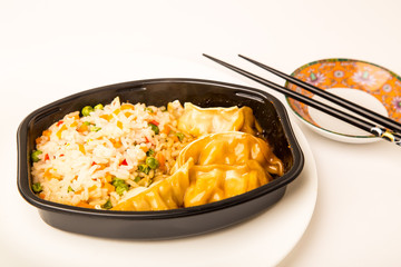 Fried Rice and Potsticker Dumplings Microwave Dinner in Plastic Tray with Chopsticks