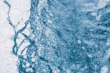 Cracked Ice On River. Big And Small Layers Of Ice. Frozen Lake Background Texture.
