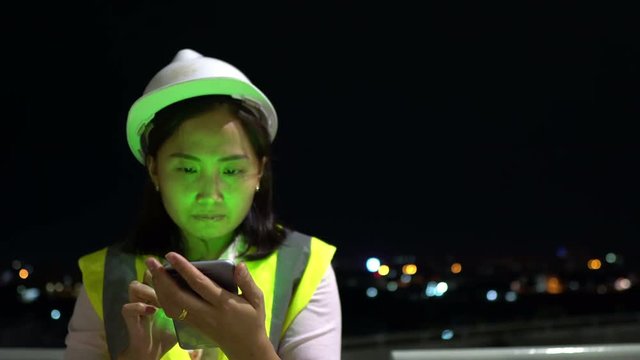Asian engineer working at site of building under construction,Work overtime at night