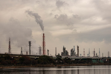 Smoke and gas rising from waterfront industrial park