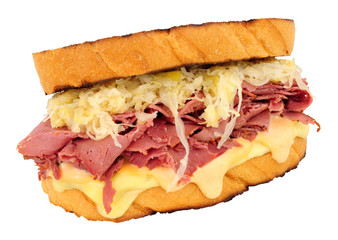 Pastrami Reuben style sandwich with sauerkraut and melted Swiss cheese isolated on a white background